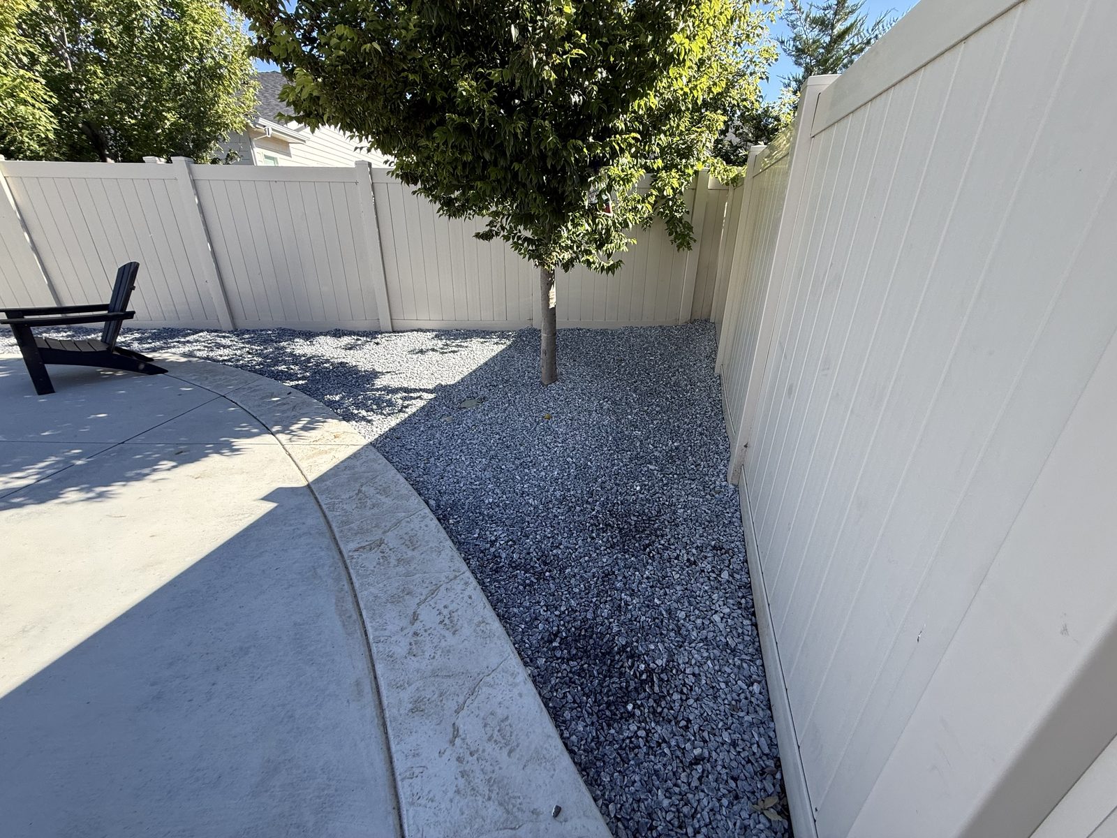 Finished back corner with blue gravel and tree — Meridian Idaho